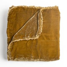 a brown blanket with ruffled edges on a white background