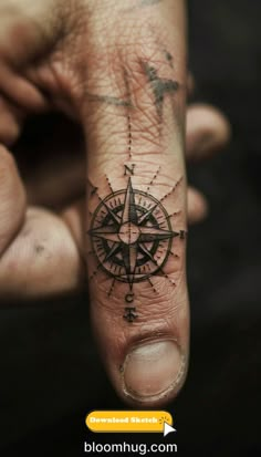 a hand with a compass tattoo on it