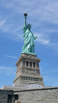 the statue of liberty is shown against a blue sky