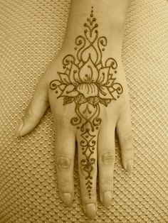 a henna tattoo on the palm of someone's hand