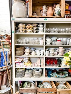 a cabinet filled with lots of plates and bowls