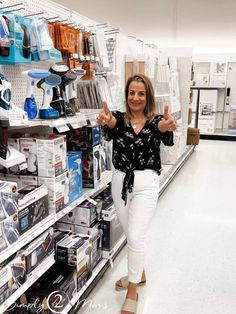 a woman is giving the thumbs up in a store