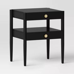 an end table with two drawers and gold knobs on the bottom, against a white background