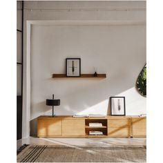 a living room with a large mirror on the wall next to a wooden cabinet and shelf