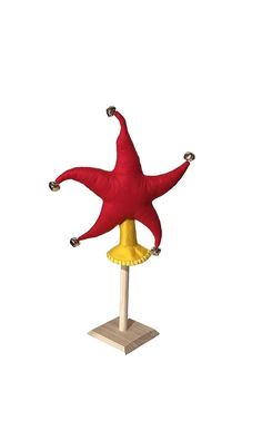 a red and yellow starfish sitting on top of a pole