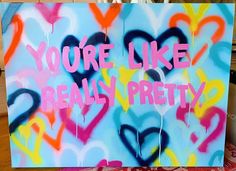 a sign that says you're like really pretty with hearts painted all over it