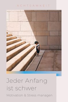 a young boy standing on top of a set of stairs