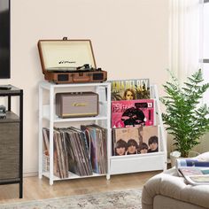 a living room filled with furniture and a flat screen tv on top of a stand