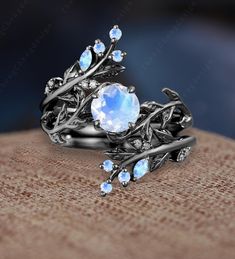 a close up view of a ring with blue stones