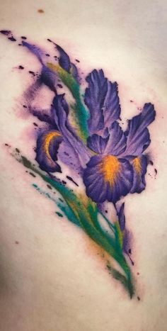 a close up of a woman's chest with flowers painted on it