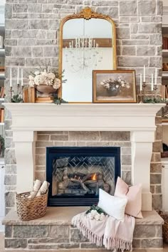 a living room with a fireplace and pictures on the mantle