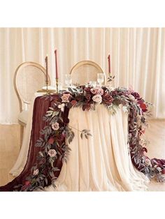 the table is decorated with flowers and candles