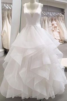 a white wedding dress on display in a store