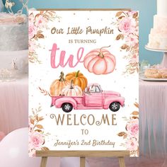 a pink truck with pumpkins on the back and welcome sign to someone's 2nd birthday