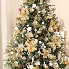 a decorated christmas tree with gold and silver ornaments