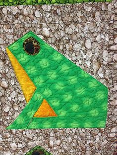 a close up of a piece of fabric with a green bird on it's side