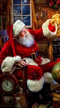 a man dressed as santa claus sitting in a chair with his hand on the clock