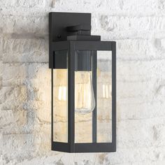 an outdoor wall light with two lights on the front and back of it, against a white brick wall