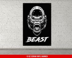 a gorilla head with the word beast on it's chest in front of a brick wall