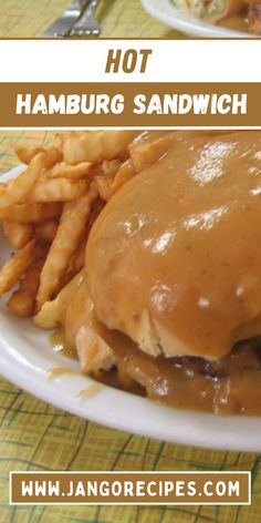 there is a sandwich with gravy and french fries on the plate next to it