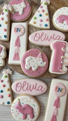 decorated cookies are arranged in the shape of letters and numbers for girls'first birthdays