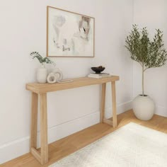 a wooden table sitting on top of a hard wood floor next to a white rug