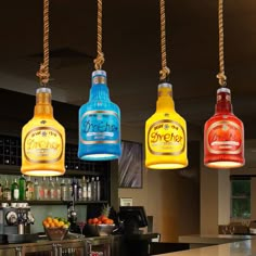 four colorful bottles hanging from the ceiling in a restaurant