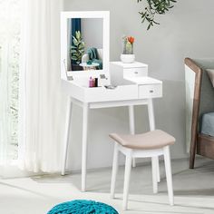 a white desk with a mirror and chair in a room next to a plant on the wall