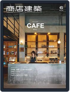 a woman standing behind a counter in front of a restaurant with the words cafe written on it