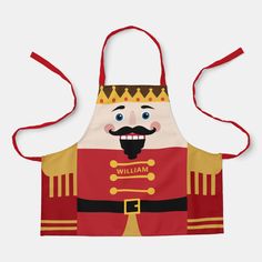 a red and yellow apron with an image of a nutcracker wearing a crown