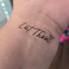 a person with a tattoo on their arm that says let there be love written in cursive writing