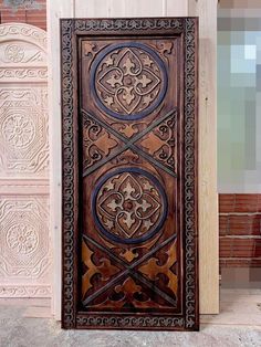 an intricately carved wooden door on the side of a building