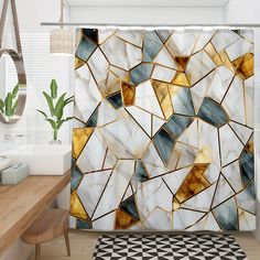 a bathroom with a shower curtain that has an abstract design on it