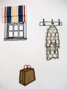 three different types of clothing hanging from hooks on a white wall next to a window