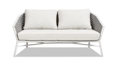 a white couch with two pillows on it's back and one pillow in the middle