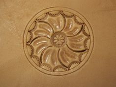 a close up view of an intricate design on a leather chair cushion with stitching