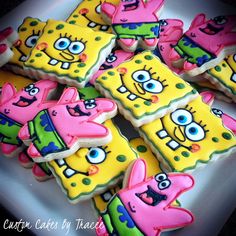 some decorated cookies on a white plate with pink and green decorations in the shape of spongebob