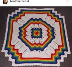 a crocheted blanket is on the floor