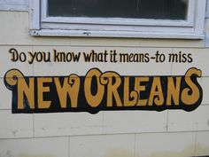 a sign that says do you know what means to miss new orleans? on the side of a building