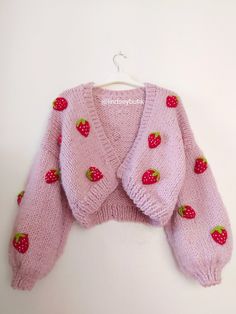 a pink knitted sweater with strawberries on it