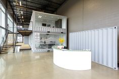 the inside of a building with stairs and tables