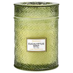 a green glass jar with a label on the lid that says, eucalyptus mint candle