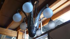 a chandelier hanging from the ceiling in a room with wood paneling and windows