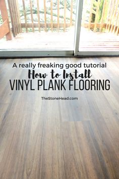 a wooden floor with the words how to install vinyl plank flooring in front of a sliding glass door