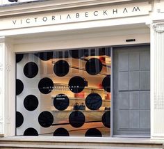 a store window with black and white polka dots on it