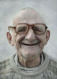 an old man with glasses smiling for the camera