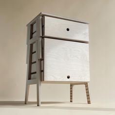 a wooden cabinet with two drawers on one side and a ladder to the other end