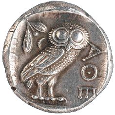 an ancient coin with an owl on it