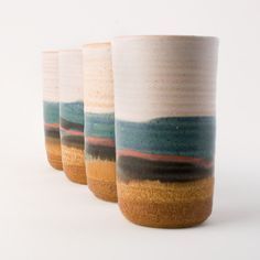 three coffee cups with different designs on them