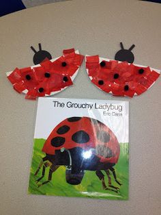 two ladybugs made out of plastic bags on top of a wall next to a book